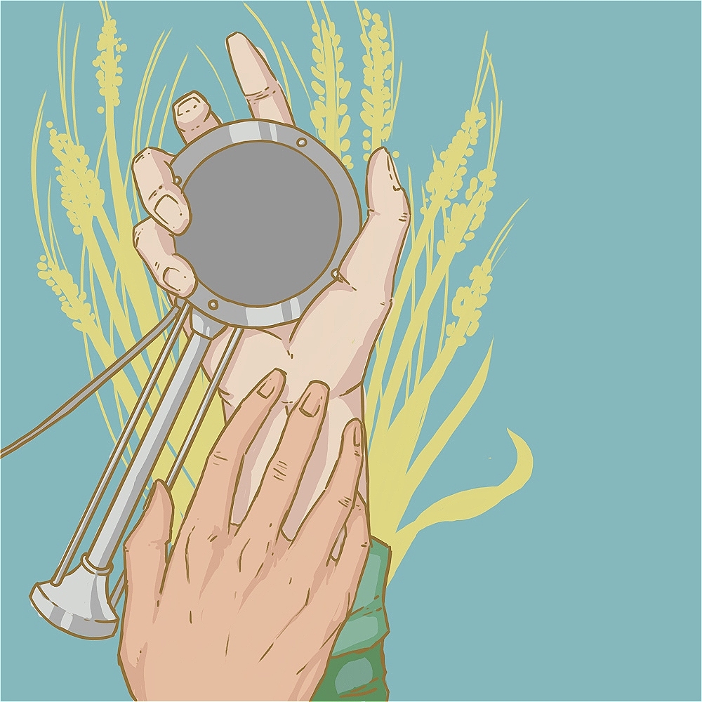 Two hands; one is holding an old-fashioned radio microphone, and the other is reaching towards it. In the background there is pale yellow wheat.