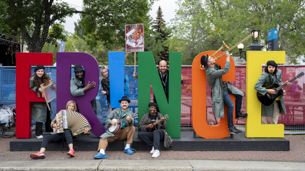 Fringe sign with artists in amongst it