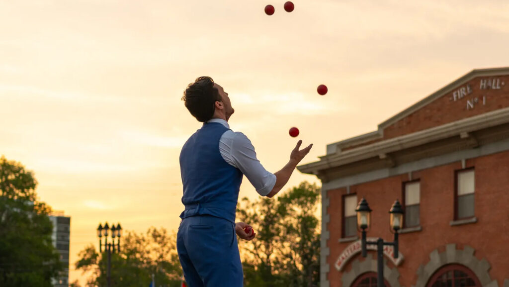 A juggler outdoors at the Edmonton Fringe Festival at sunset